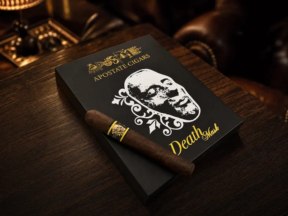 Black Apostate Death Mask box with the white death mask artwork and a San Andrés robusto resting on the lid