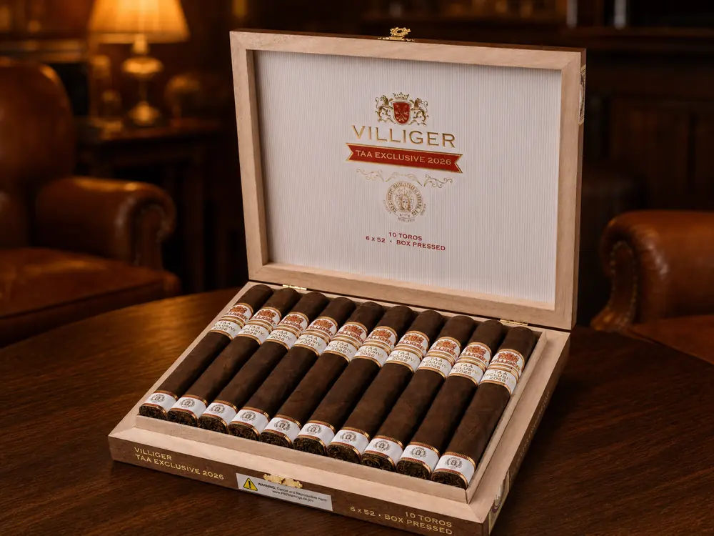 Open Villiger TAA Exclusive 2026 box with ten box-pressed toros on a walnut table