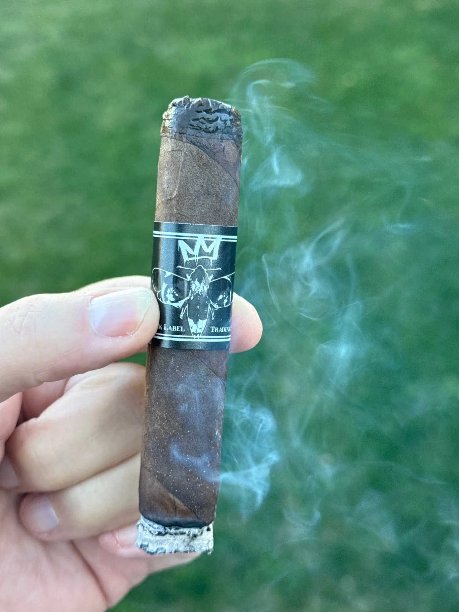 The lit Morphine 10 Year Anniversary Toro with a short ash